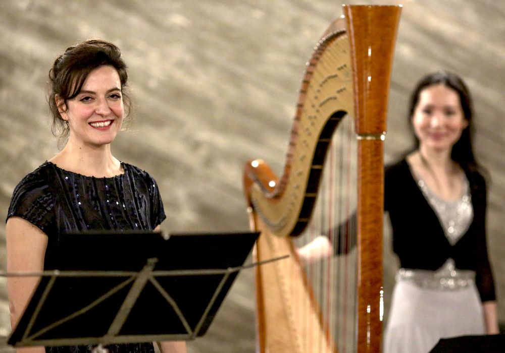 The interpreters after a performance of “Songs in Pictures”. Both women are holding a nosegay